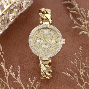 Close-up of golden diamond-encrusted dial and Cuban chain strap with chronograph details