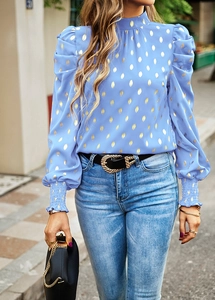 Close-up of blue long-sleeve blouse with gold polka dots and elastic puff sleeves