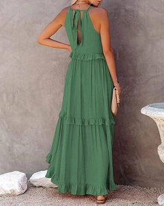 Detail of green tiered maxi dress with ruched texture and elegant halter neck ties