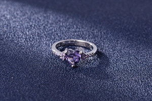 Macro shot of S925 sterling silver ring featuring a heart-shaped purple amethyst gemstone