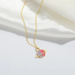 Detail of gold necklace with Saturn pendant featuring pink and purple enamel and zircons