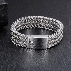 Close-up of a men's chunky stainless steel braided chain bracelet with a wide clasp