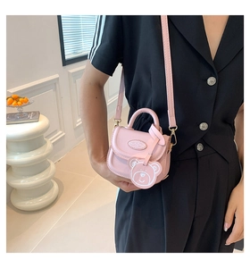 Pink mini crossbody bag featuring a cute 3D bear pendant and adjustable shoulder strap