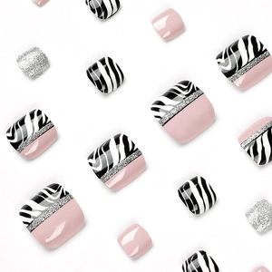 Pink press-on toe nails with silver glitter and black-white zebra pattern accents