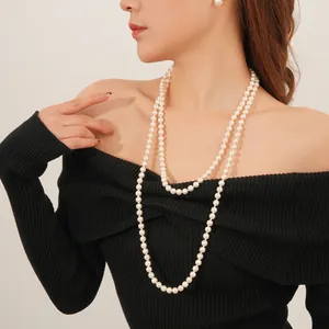 French vintage double-layer pearl necklace and stud earrings set on a black top
