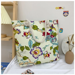 Floral canvas tote bag with thick beige rope handles and vibrant bird prints