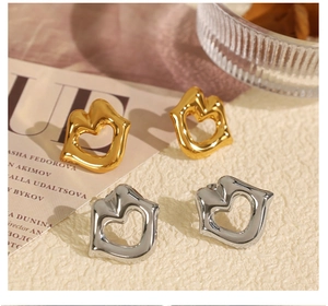 Detail view of liquid metal lip earrings and hollow heart studs in gold and silver finish