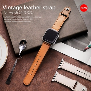 Brown and off-white vintage leather straps for Apple Watch in a business desk setting