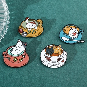 Detailed view of four cute cartoon cat and rabbit enamel pins on green velvet texture