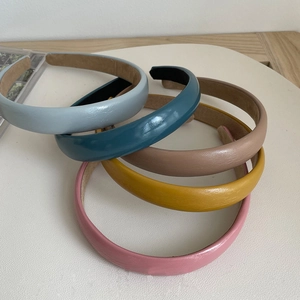 Stack of vintage leather headbands in light blue, dark blue, brown, yellow and pink