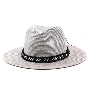 Light gray woven fedora sun hat with black and white band and silver rivet accents