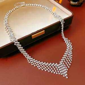 Detailed view of silver crystal tassel necklace featuring V-shape fringe on jewelry box