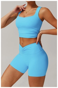 Detail of sky blue sports vest and shorts with ruched waist and high-stretch fabric