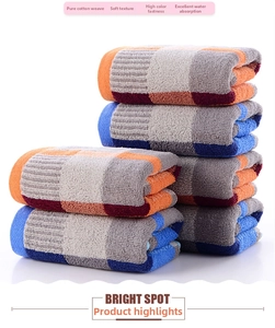 Detail of soft cotton towels with orange and blue stripes showing honeycomb loop texture