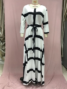 Detail of plus size striped midi dress featuring black grid pattern and waist tie belt