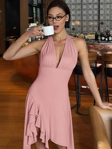 Pink halter neck dress with deep V-neck and asymmetric ruffled hem in professional studio shot