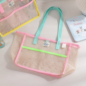 Mesh beach bag detail with pink trim and mint green handles for large storage