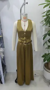 Detail of satin V-neck vest with gold buttons and matching high-waist wide-leg pants