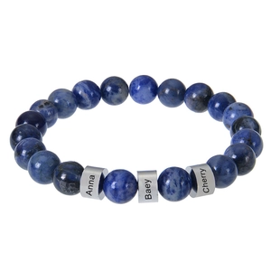 Close-up of blue tiger eye stone bracelet with personalized engraved silver cylinders