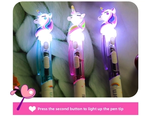 Close-up of three glowing unicorn ballpoint pens in blue, pink, and purple colors