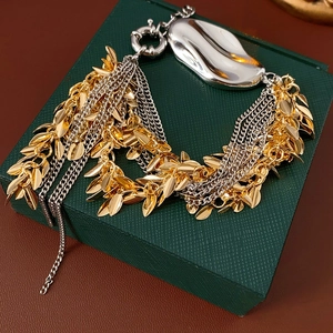 Close-up of multilayer wheat tassel bracelet with gold leaves on a jewelry box