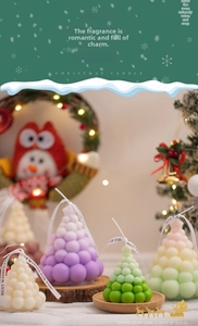 Macro view of colorful bubble Christmas tree candles with ribbon on a festive background