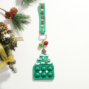 Close-up of green Christmas tree silicone push pop toy with metal keychain and festive pine decor