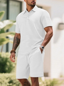 Detail view of white waffle knit texture on men's casual polo shirt and shorts set