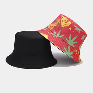 Detail view of double-sided bucket hats featuring black solid and red cannabis leaf prints