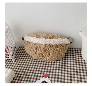 Close-up of brown plush sherpa belt bag with cute cartoon bear embroidery detail