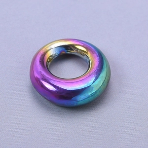 Close-up of a rainbow plated 304 stainless steel oval pendant with a smooth metallic finish