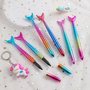 Detail showing colorful mermaid tail pens with scaled texture and gradient metallic finish