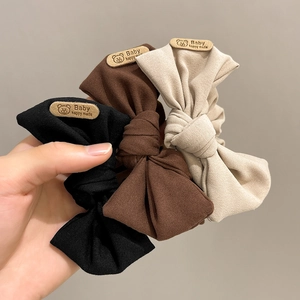 Three-piece set of baby bow headbands in black, brown and beige with bear labels