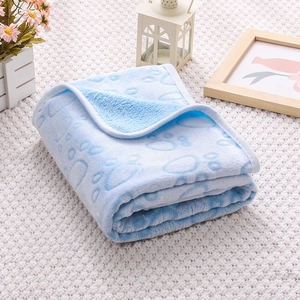 Close-up of soft blue flannel pet blanket with cute paw prints and neat stitched edges
