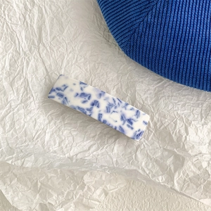 Detailed macro view of the blue and white marble pattern on this elegant hair claw clip