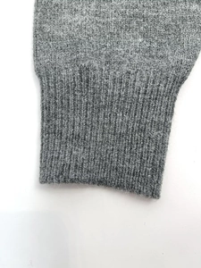 Close-up of the grey ribbed knit cuff showing detailed wool texture and soft fabric fibers