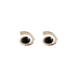 Retro silver spiral earrings with black oval gemstone on a minimalist white background