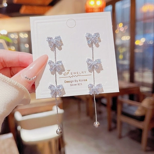 Elegant S925 silver bow tassel earrings with sparkling rhinestones on jewelry card