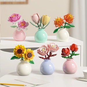 A set of six colorful building block flowers in macaron vases for home office decor