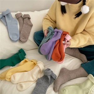 Close-up of colorful ruffled knit socks for women in blue, yellow, and pastel tones