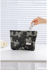 Detail of grey butterfly embroidery on cosmetic bag with high-end jacquard texture