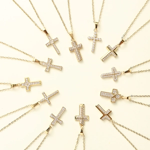Detailed arrangement of twelve diverse gold cross pendants with sparkling cubic zirconia