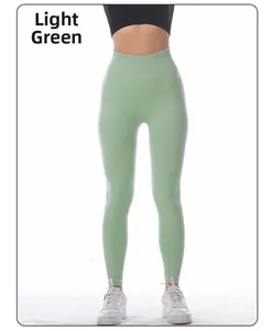 Detail of high waisted seamless yoga leggings in light green with moisture-wicking fabric