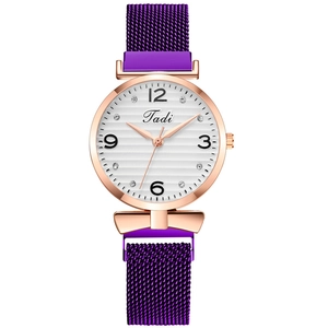 Detail of purple Milanese mesh strap and rose gold watch case with crystal diamond dial