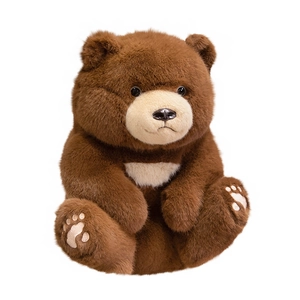 Cute brown sitting teddy bear plush toy with embroidery paws on a white background