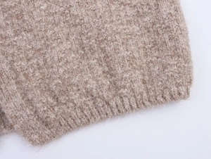Detail shot of khaki chunky knit cardigan featuring soft wool texture and ribbed hemline