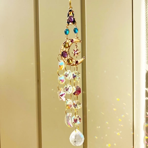 Detail of moon and star suncatcher with colorful crystals and rainbow prism light