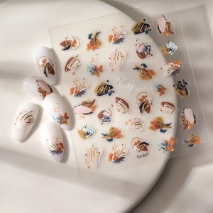 Detail of 5D embossed nail art stickers with gold foil outlines and colorful abstract patterns