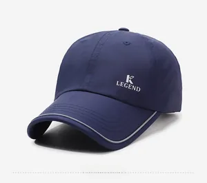 Detail showing the white K LEGEND logo and reflective strip on the navy baseball cap
