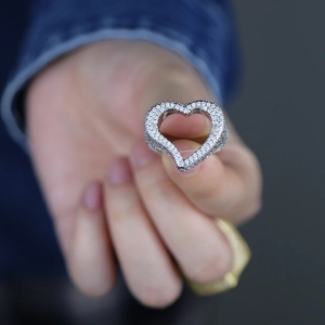Close-up of hip hop silver ring with hollow heart shape and white zircon stones